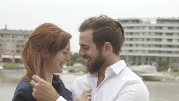 Affectionate couple laughing together outdoors