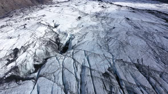 Aerial View of Solheimajokull Glacier, Iceland. Crevasse and Black Volcanic Ash Captured in the Ice