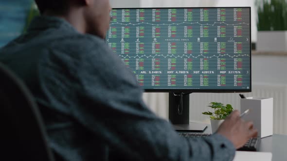 African American Man Looking Into Crypto Currency Stock Markets Trading Checking Stock Ticker Index