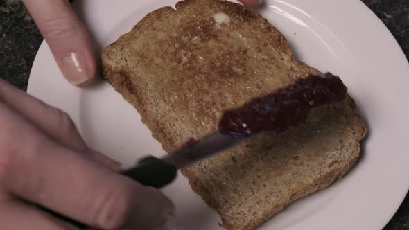 jam spread on slice of toast