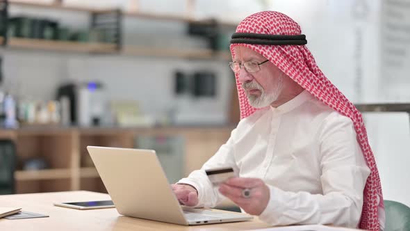 Senior Old Arab Businessman Having Online Payment Failure on Laptop