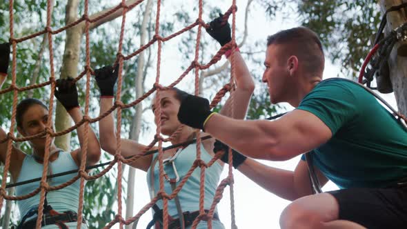 Trainer instructing group of woman to net climb 4k