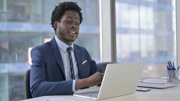 Handsome African American Businessman Doing Video Chat on Laptop
