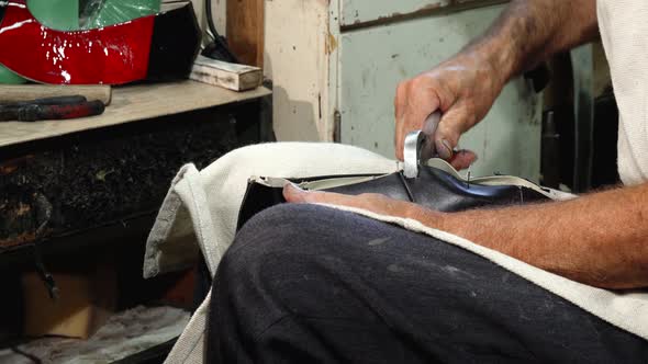 Professional Shoemaker Using Hammer While Making New Shoes