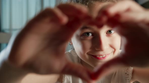 Beautiful Happy Little Cute Child Face Adorable Girl Kid Seen Through Joined Fingers Making Heart