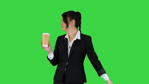 Beautiful Young Businesswoman Having a Coffee Break with Take Away Coffee and Dancing on a Green