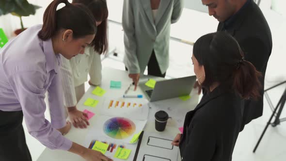 Business People Proficiently Discuss Work Project on Meeting Table