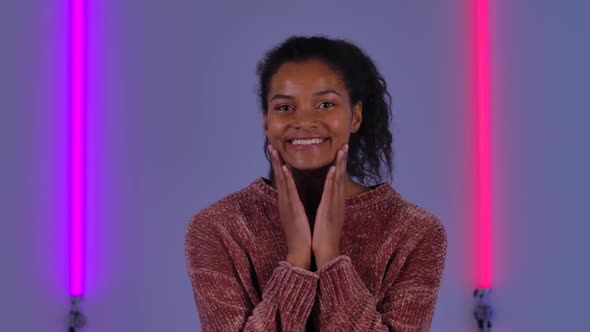 Portrait of Afro American Young Woman Looking at Camera with Wow Delight and Joy