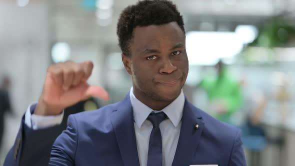 Portrait of Thumbs Down Gesture By African Businessman