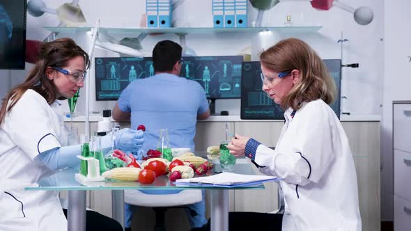 Female Scientist Testing GMO Samples on Vegetables