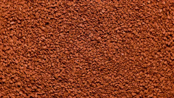 Full Frame Slowly Spinning Background of Freezedried Instant Coffee Granules Extreme Closeup View