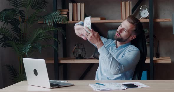 Successful Business Man Counting Money at Workplace