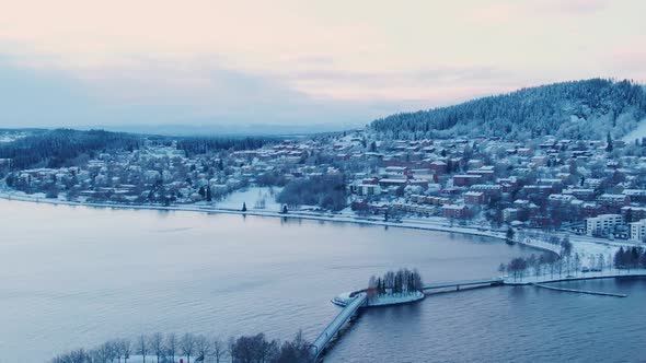 Drone pan shot over Scandinavian small town on cold winter day