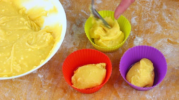 Woman Falls Asleep with a Spoon Yellow Dough in a Muffin Baking Dish at Home in the Kitchen