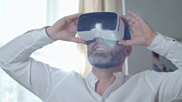 Excited Middle-Aged Man in VR Headset