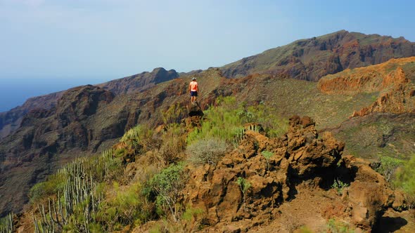 Man Traveler Enjoys Nature Landscape in Hike to Gorge