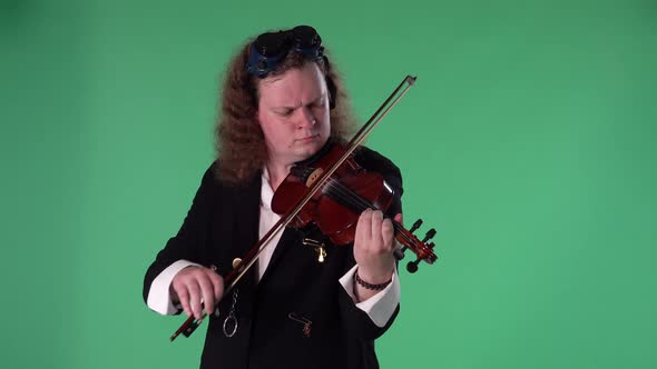 A Violinist in a Black Suit and Original Glasses on His Head Plays the Violin Masterly