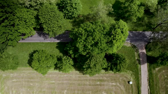 Aerial Top Down View of Rural Countryside Empty Roadway, Country Trail intersection of Paved Road an