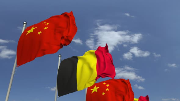 Flags of Belgium and China Against Blue Sky