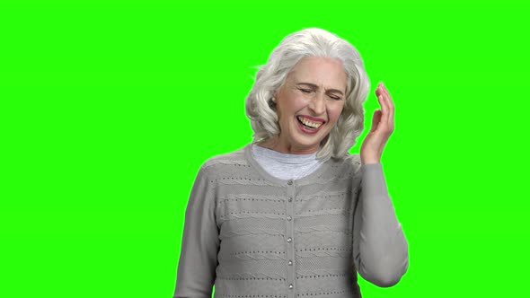 Joyful Elderly Lady Is Laughing on Green Screen