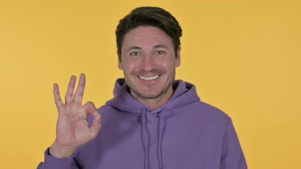 Man with OK Sign, Yellow Background 