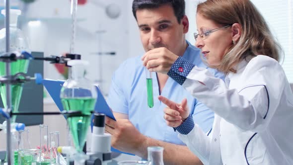 Assistant Is Taking Notes From a Senior Biotechnologist