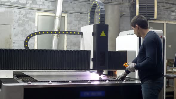 Engineer Worker Controls the Cutting of Metal Plates