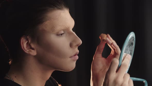 Drag Artist  Young Man Blending in the Thick Foundation on His Eyebrows