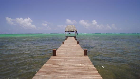 Peaceful Dock With Hammock Under Thatched Canopy Tracking Toward Caribbean Sea