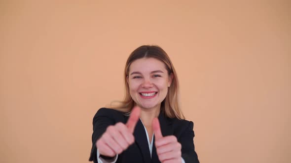 Young Business Woman Showing Thumbs Up Laughs and Dancing in Studio Dressed Black Jacket