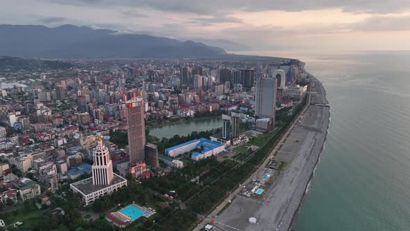 Top aerial view of beautiful lake in the center of Batumi at sunset. flying over 6 May park