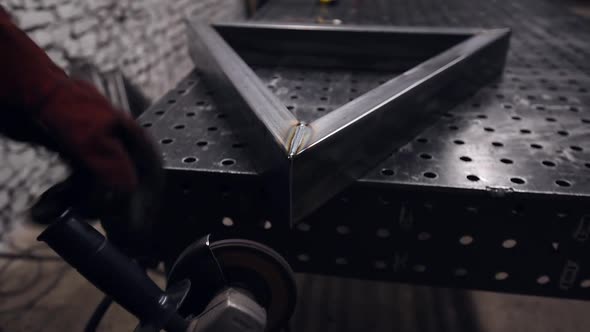 Worker Cutting Metal with Grinder