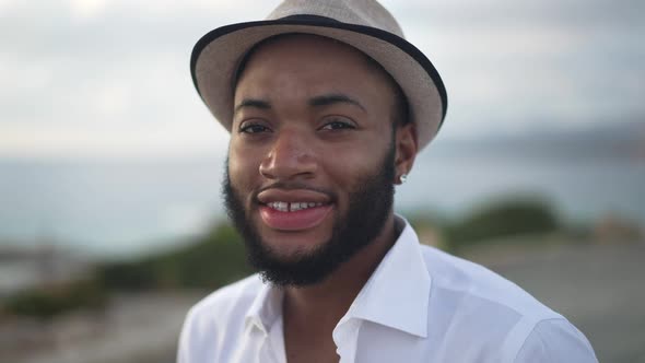 Closeup of Handsome Confident African American Gay Man with Toothy Smile and Brown Eyes Looking at