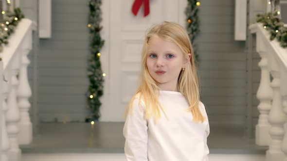 Portrait of a Teenage Girl of Caucasian Nationality Who Closes Her Eyes with Her Hands and Opens