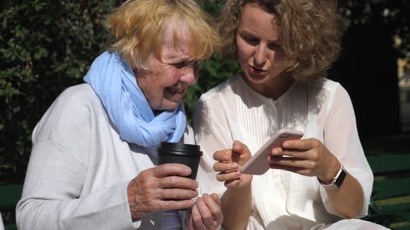 People And Technology Concept. Grandmother And Granddaughter Using Smartphone