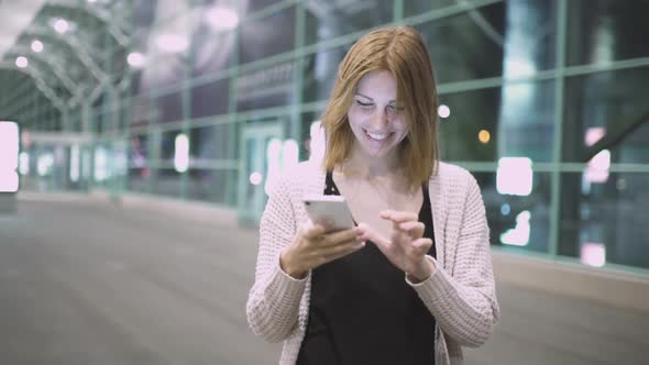 Young Pretty Redhaired Woman Using Her Smatphone