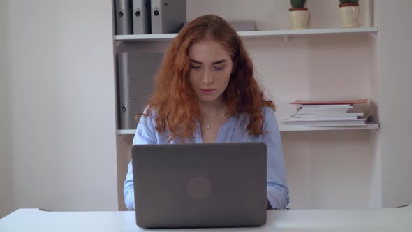 Young Woman with Curly Hair Work on PC