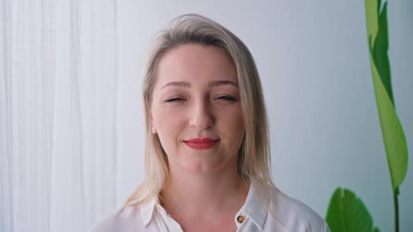 Portrait of a Young Blonde Caucasian Joyful Woman Closeup Indoors Wellbeing Concept