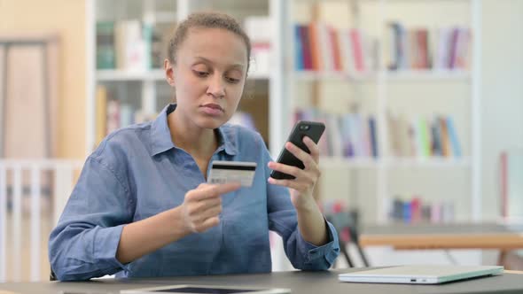 Successful Online Payment on Smartphone By African Woman in Library