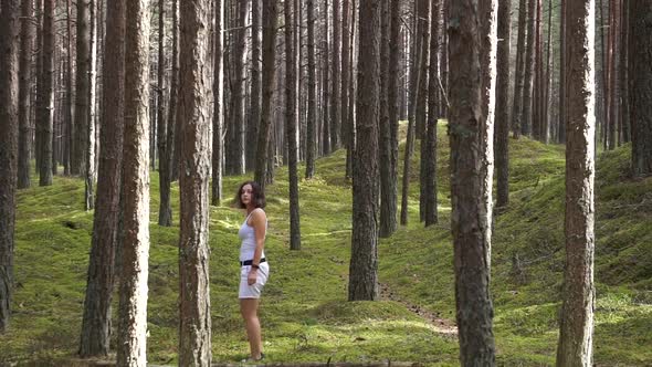 Girl playing hide and seek in the forest