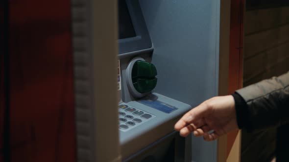 Man Using His Credit Card in an Atm for Cash Withdrawal Pin Code Money Shopping Mall or City Street