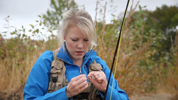Woman Ties On A New Fly For Fly Fishing