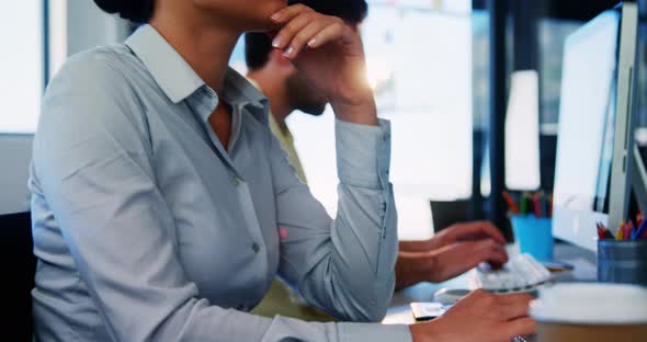 Business executives working over computer