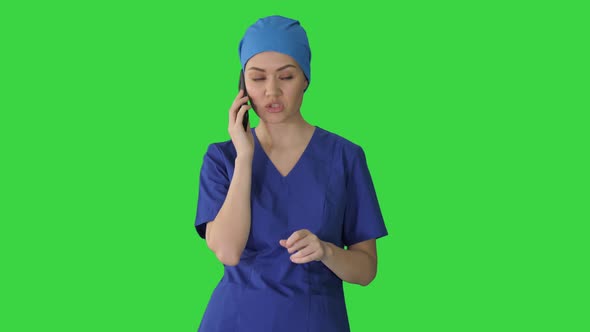 Serious Female Doctor Talking on the Phone on a Green Screen, Chroma Key.