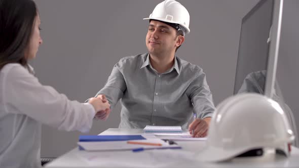 Engineers working and shaking hands.