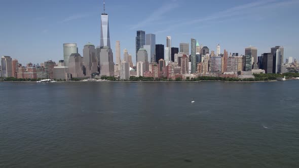 Aerial view of skyscrapers of lower Manhattan, in sunny NYC, USA - rising, drone shot