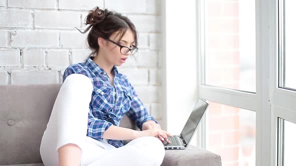 A Woman Using Mouse and Keyboard To Surfing Internet Whie Sits at Home