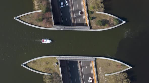 Aerial TOP DOWN Veluwemeer Aqueduct view from above, boat sailing across aquaduct over traffic tunne