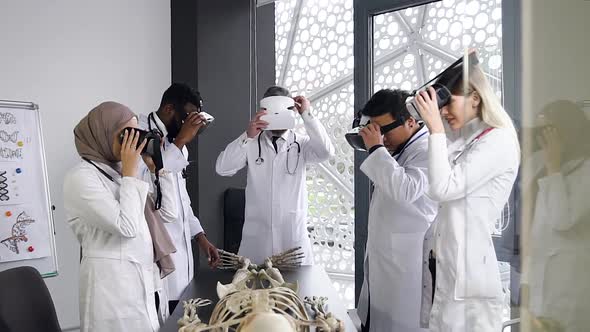 Male and Female Doctors Wearing Virtual Reality Headset to Learn the Structure of Human Skeleton