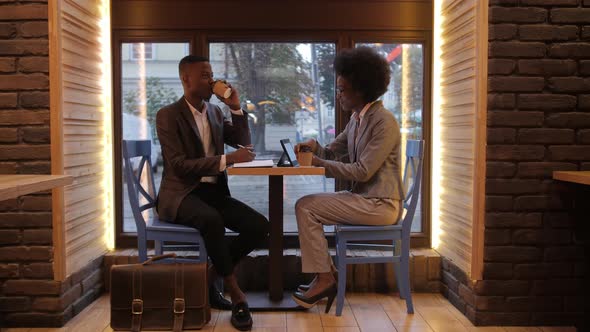 African Partners Drinking Coffee During Meeting at Cafe